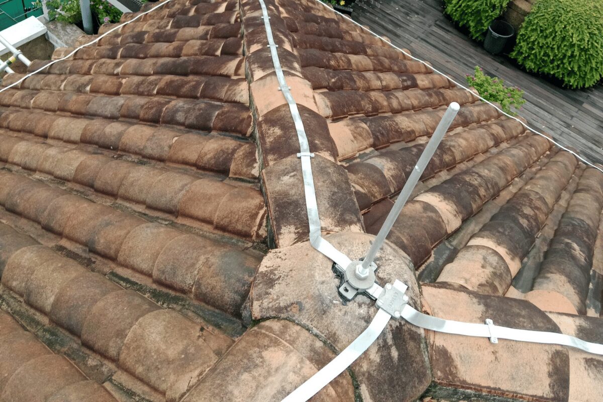 Lightning protection conductors running along a tiled roof ridge